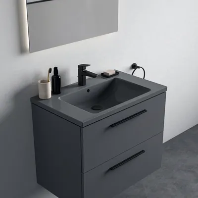 A modern bathroom vanity with a sink and faucet.