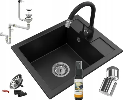 A black granite kitchen sink with a black faucet and various plumbing accessories and cleaning spray are displayed against a white background.