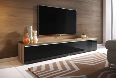 A modern living room with a TV stand and television.