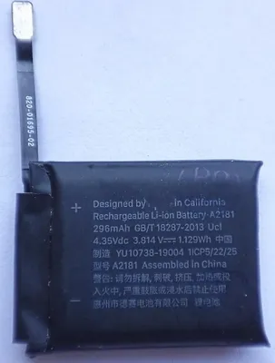 A close-up of a black rechargeable lithium-ion battery with text labels.