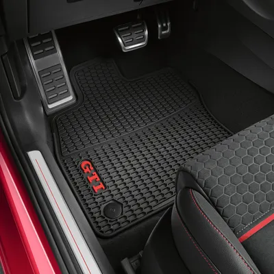 Interior view of a car's driver's side floor with custom floor mats.