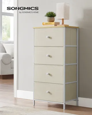 A SONGMICS chest of drawers with four fabric drawers is shown in a room setting, next to a sofa and a window.