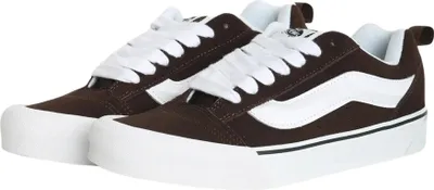 A pair of brown Vans sneakers with white laces and a white side stripe, shown against a white background.