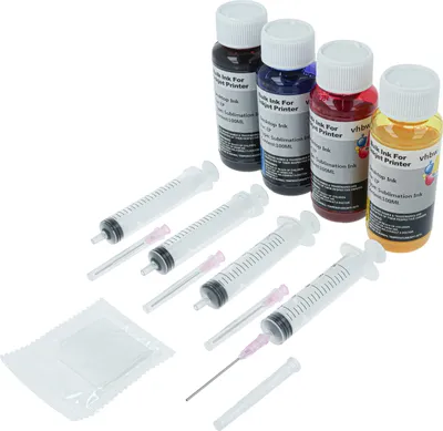 A set of four bottles of sublimation ink and four syringes with needles, arranged on a white background.