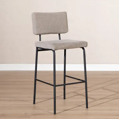 A bar stool is shown in a room with a light-colored wall and wooden floor.