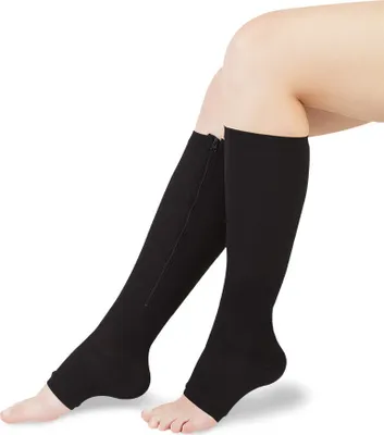 A close-up shot of a person's legs wearing black compression socks.