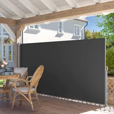 A patio with furniture and a retractable side awning.