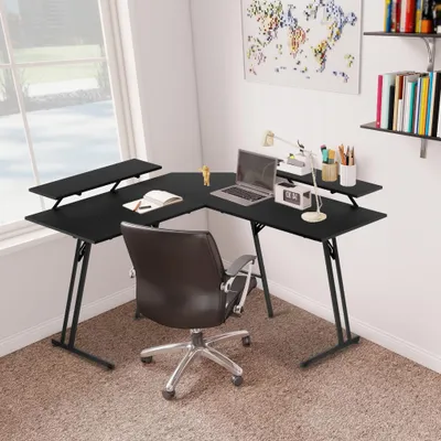 A corner desk setup in a room with a window and a world map on the wall.
