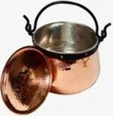 A copper pot with a lid next to it, on a white background.