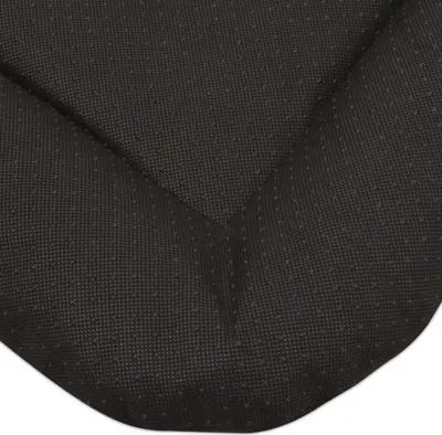 A close-up view of the textured black fabric of a dog bed, showing the dotted pattern on the underside.