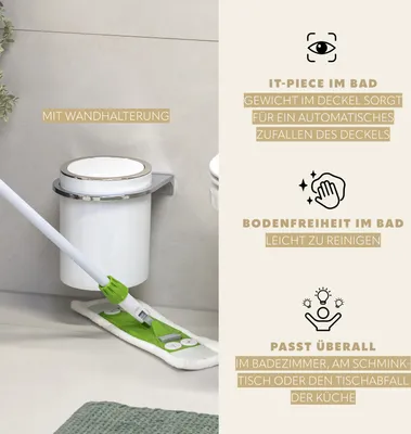 A bathroom scene showing a white trash can mounted on a wall with a mop cleaning the floor.