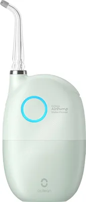 A mint green water flosser with a clear nozzle is shown against a white background.