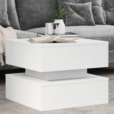 A white coffee table in a living room setting with a couch in the background.