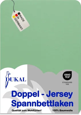 A light green fabric with product branding and certifications.