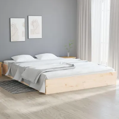 A bedroom scene with a wooden bed frame and white bedding.
