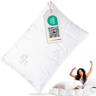 A pillow with a tag and a woman stretching in bed.