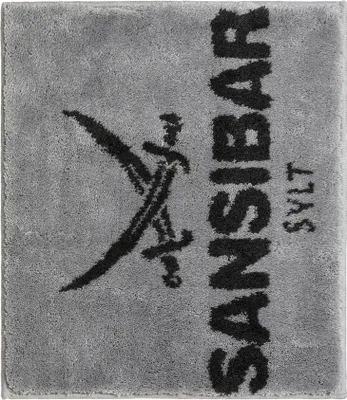 A close-up of a gray bath mat with black text and a logo.
