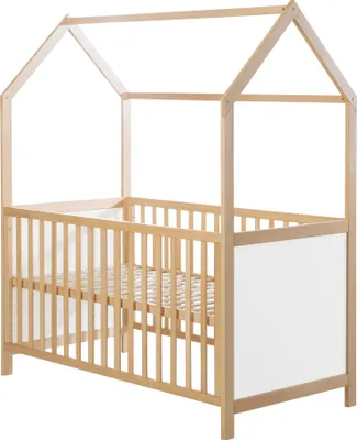 A wooden crib with a house-shaped frame against a white background.