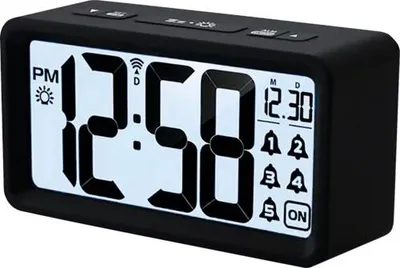A black digital alarm clock with a white display showing the time and alarm settings.