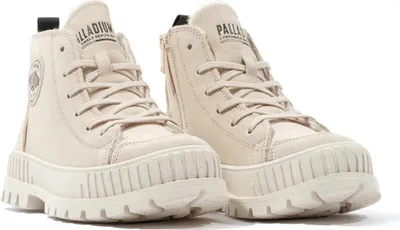 A pair of beige Palladium high-top boots with thick soles and laces, shown from a front-side angle against a white background.