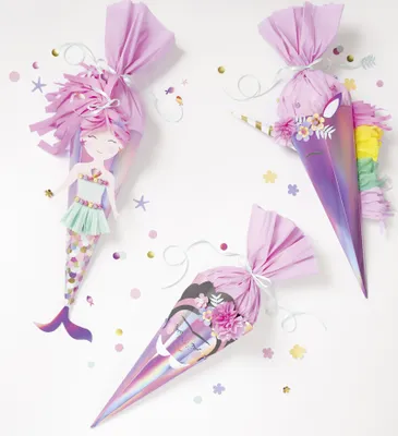 Three decorative cones with fantasy themes (mermaid and unicorn) are arranged on a white background, surrounded by confetti.