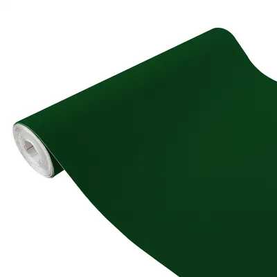 A roll of dark green velvet fabric or wallpaper.