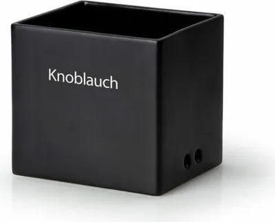 A black ceramic storage container for garlic, with the word "Knoblauch" (German for garlic) printed on the front.