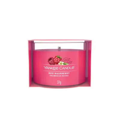 A Yankee Candle Red Raspberry votive candle in its packaging.