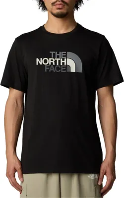 A man wearing a black t-shirt with a logo.