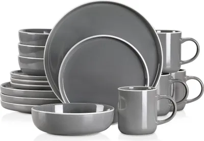 A set of grey stoneware dishes and mugs are neatly arranged.