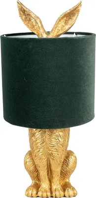 A gold-colored rabbit-shaped table lamp with a dark green lampshade.
