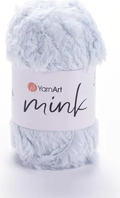 A ball of light blue fluffy yarn with a white label wrapped around it.