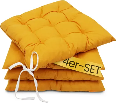 A stack of four yellow seat cushions.