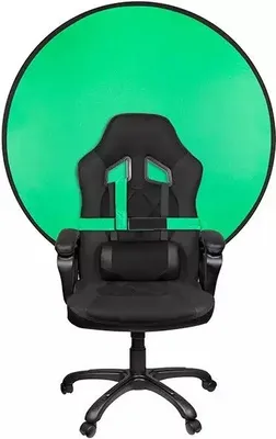 A black gaming chair with a green screen backdrop.