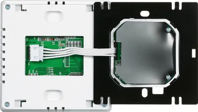 The back of a smart digital thermostat is shown, with its internal circuit board and wiring visible.