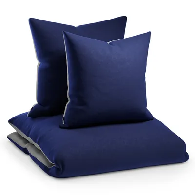 A stack of navy blue bedding items, including two pillows and a duvet cover, against a white background.