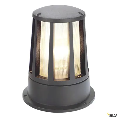 A dark gray outdoor lamp with a cylindrical base and a fluted glass shade, illuminated from within.