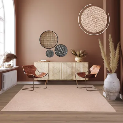 A living room scene with a rug, chairs, and a sideboard.