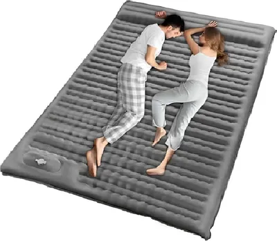 A couple sleeping on an inflatable mattress.