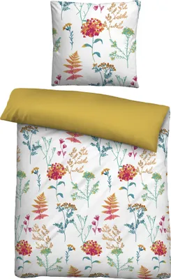 A flat lay of a duvet cover and pillowcase with a floral pattern, and a solid yellow pillow.