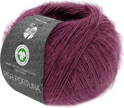 A ball of burgundy yarn with a label wrapped around it.