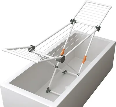 A white drying rack is placed over a white bathtub.
