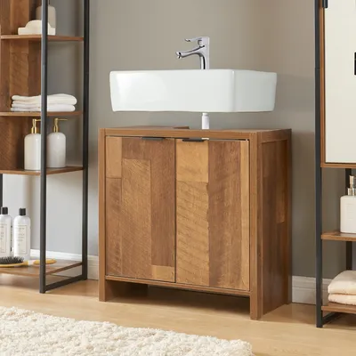 A bathroom vanity with a sink and faucet, next to a shelving unit.