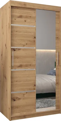 A wooden wardrobe with a mirrored door, reflecting a bedroom interior.