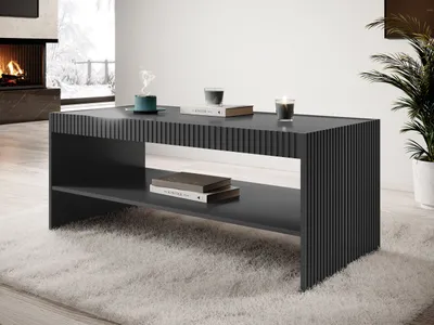 A modern living room with a fireplace, a large window with a winter view, and a plant. A dark gray coffee table with a ribbed design is placed on a fluffy white rug.