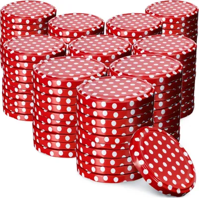 A collection of red and white polka dot jar lids stacked in various piles.