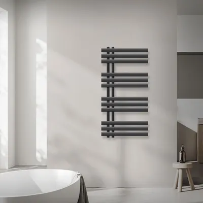 A modern bathroom with a freestanding bathtub and a dark anthracite radiator mounted on the wall.