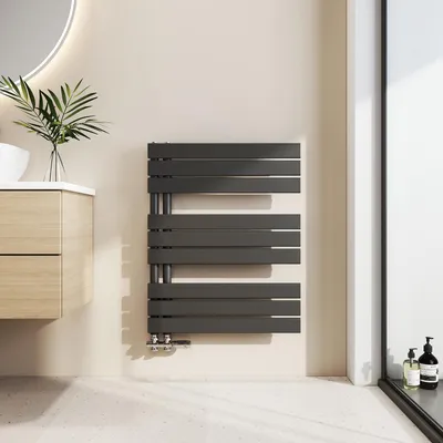 A modern bathroom with a vanity, sink, and a dark gray towel radiator.