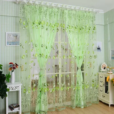 A room with green striped walls and light green sheer curtains with a floral print.