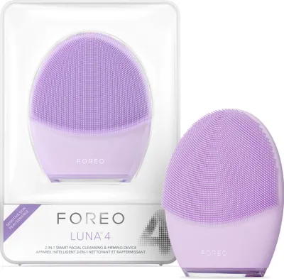 A product shot of a purple FOREO LUNA 4 facial cleansing device in its packaging, with a second device shown outside the packaging.